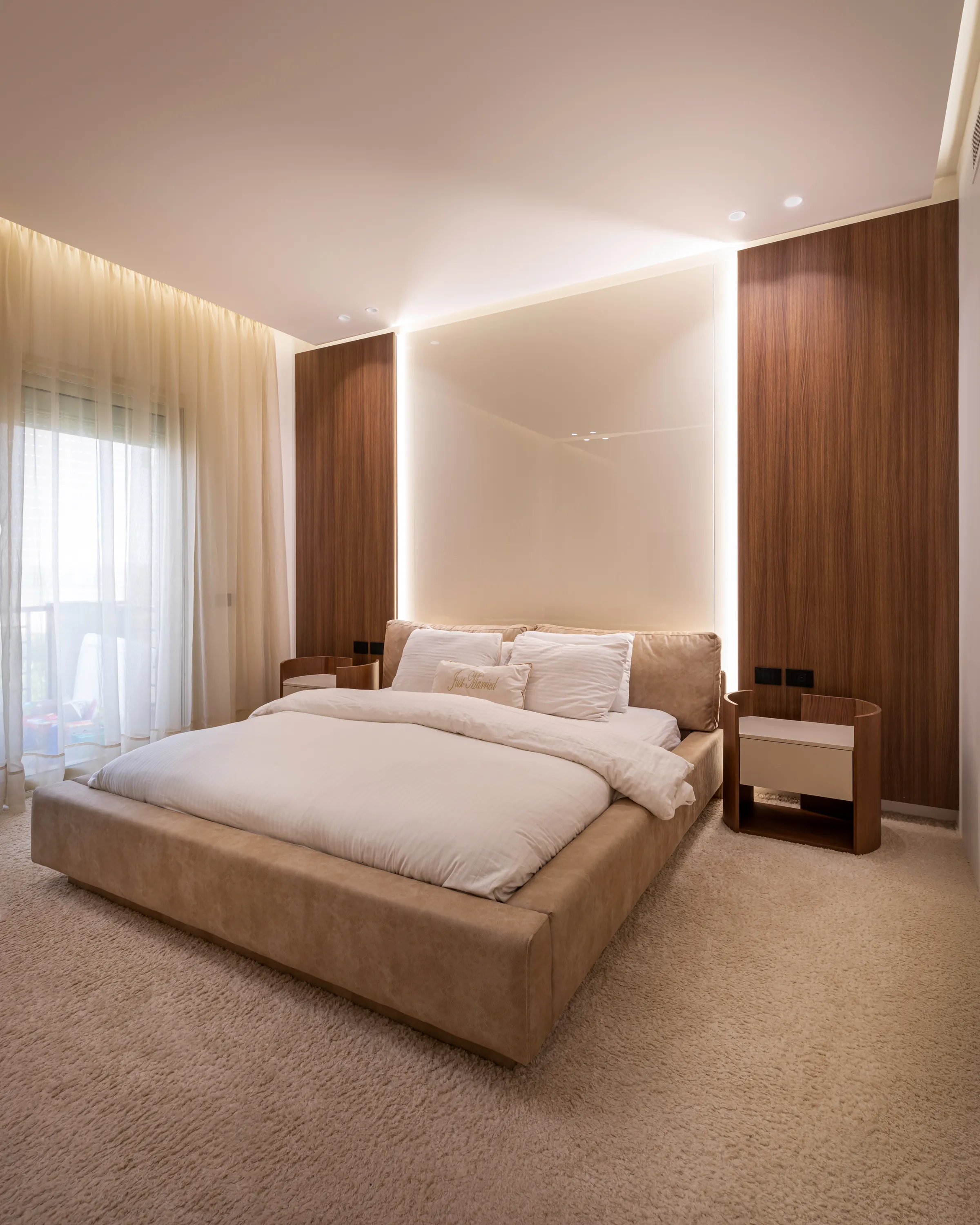 Custom bed and upholstered headboard wall, New Giza Villa bedroom by Modoro