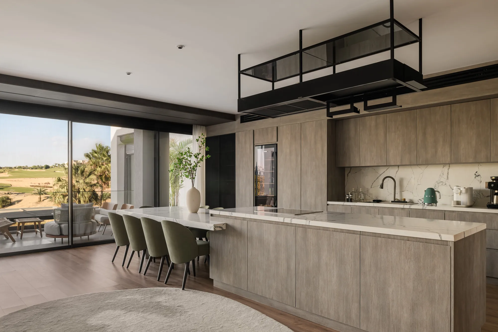 Custom kitchen island in stone with integrated appliances, Palm Hills Residence by Modoro