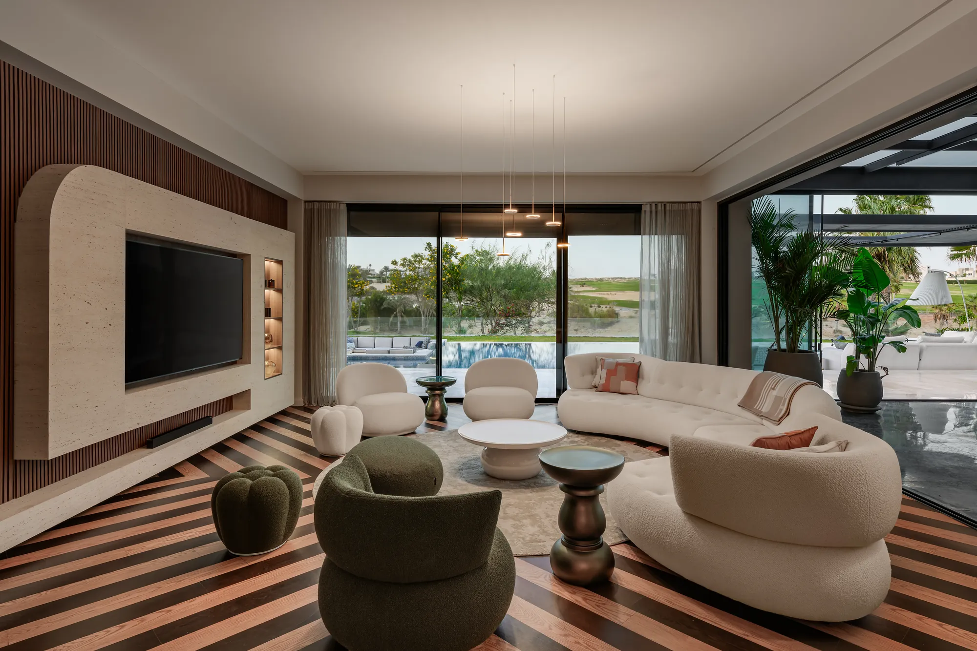 Curved custom media wall, Palm Hills Residence living room by Modoro